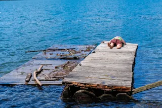 Jereme lying on a dock