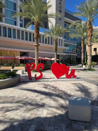 The red "PS loves U" letters in a downtown plaza