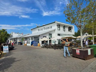 Euri waving in front of the white Roche Harbor general store