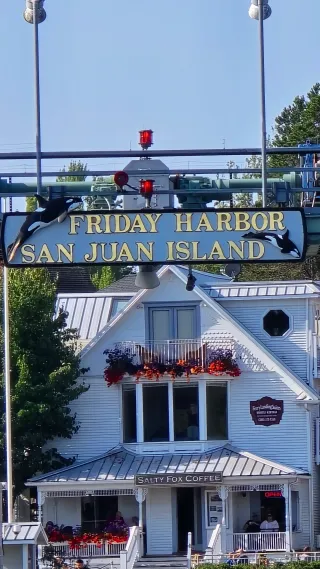 The "Friday Harbor, San Juan Island" sign with orcas, over the ferry landing
