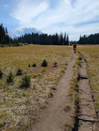 Euri walking ahead on the trail across Grand Park toward the mountain