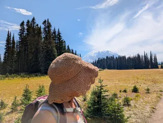 Euri's straw hat in the foreground, looking out toward Mount Rainier